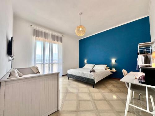 a bedroom with a bed and a blue wall at Maison Pompei in Pompei