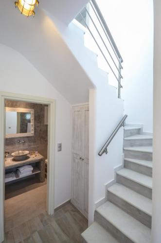 a staircase leading to a bathroom with a sink at My Villa Naxos in Naxos Chora