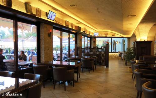 a dining room with tables and chairs in a restaurant at Motel pizzeria Antic's in Laktaši