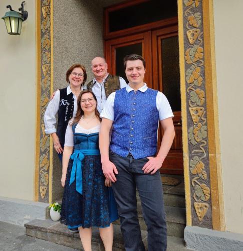 a group of people standing in front of a building at Gasthof-Fleischerei Engl in Kötschach