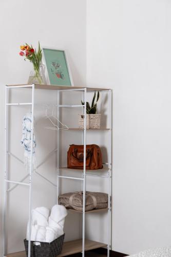 a white shelf with towels and a purse on it at Maison Pompei in Pompei