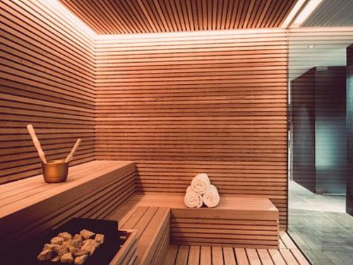 a sauna with two towels and a pair of slippers at SLS Buenos Aires Puerto Madero in Buenos Aires