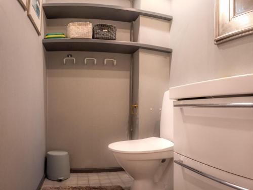 a small bathroom with a toilet and a sink at Mäntypirtti Log Villa in Rovaniemi