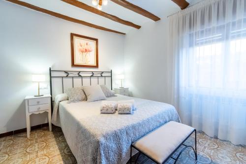a bedroom with a bed with two pillows on it at CASA LA FELICIDAD in Beceite