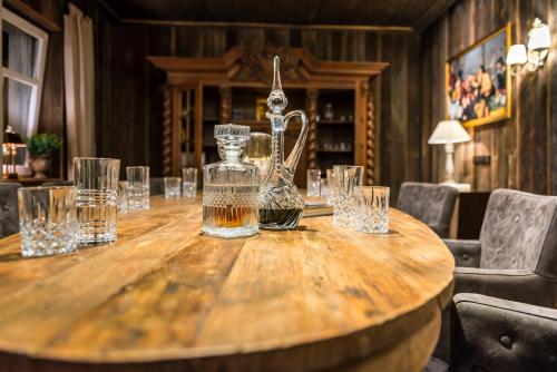 a wooden table with glasses and a jug on it at Hotel Wellness Goldenes Fass Meißen in Meißen
