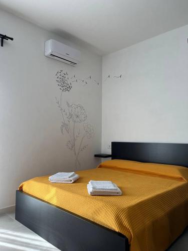 a bedroom with a bed with two towels on it at Apartment, Sulina's House in Campofelice di Roccella