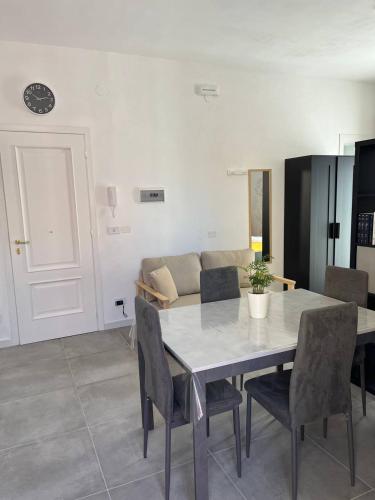 a dining room with a table and chairs and a couch at Apartment, Sulina's House in Campofelice di Roccella