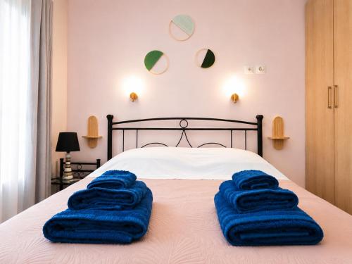 a bed with blue towels sitting on top of it at Petit house Vrachati in Vrachati