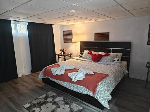 a bedroom with a bed with towels on it at Spacious Basement Lower Suite 3BR Home Stay 1 King 2 Queen Beds 2 Car Parkings FIFA 2026 in Pickering