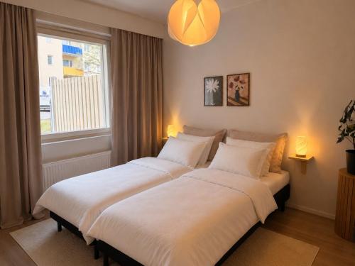 a bedroom with two beds and a window at Central location with sauna, private yard & parking in Rovaniemi