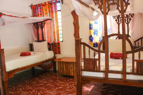 a room with two bunk beds and a window at Sagando Bungalow in Michamvi