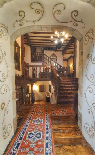 a room with a staircase and a rug on the floor at Hotel Altamira in Santillana del Mar