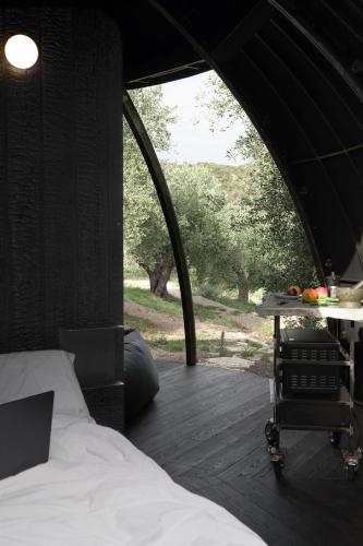 a bedroom with a bed and a table in a tent at Cosmo Camp in Montepescali