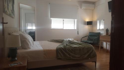 a bedroom with a bed and a desk and a chair at Moradia Vinhais in Vinhais