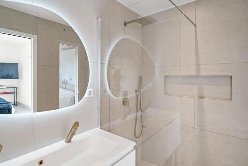 a bathroom with a shower and a sink and a mirror at Corgona Villa in Cannes