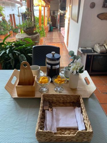 a wooden table with a tray of food on a table at Hotel Casa Posada Don Chepe in San Gil