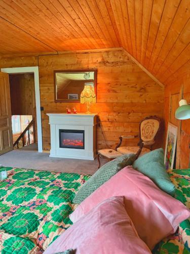 a bedroom with a fireplace and a bed in a room at Meiriet1936 in Fjarland