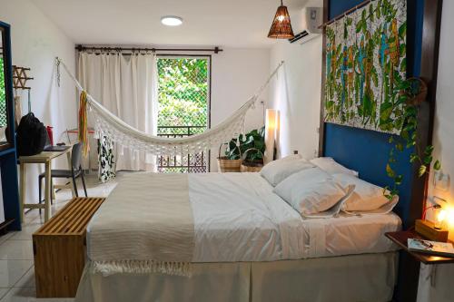 a bedroom with a large bed and a window at Pousada Barra Velha in Maragogi