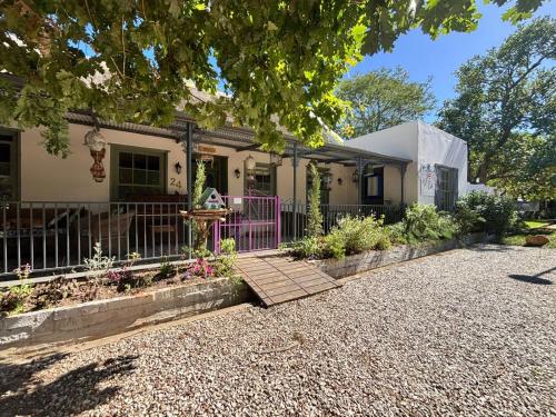 a house with a fence and a walkway at Greyton Toad Hall in Greyton