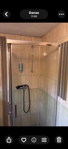 a shower with a glass door in a bathroom at Kuca Delić in Račić