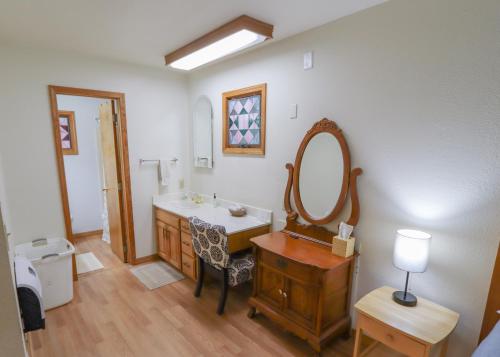 a bathroom with a sink and a mirror at Over the Rainbow Suites in Eureka Springs