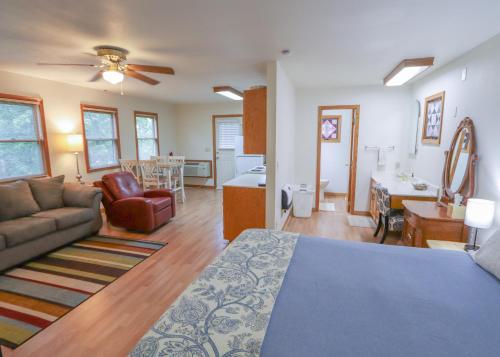 a living room with a bed and a couch at Over the Rainbow Suites in Eureka Springs