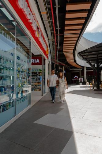 a man and a woman walking down a sidewalk at Cerritos Premium Tower & Mall in Pereira