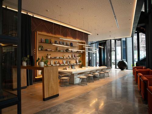 a lobby with a long table and chairs and windows at Pullman Lima Miraflores in Lima