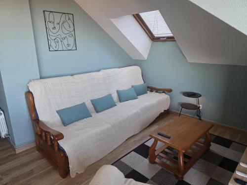 a living room with a couch and a table at Atico in Noja Helgueras in Noja