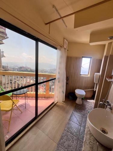a bathroom with a view of a balcony at Aizawl Hotel in Āīzawl