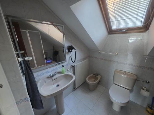 a bathroom with a sink and a toilet at Atico in Noja Helgueras in Noja