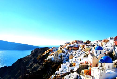 a view of a town on the side of a mountain at Aspaki by Art Maisons in Oia