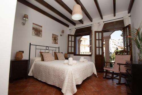 a bedroom with a bed with two candles on it at Casa Teones con piscina privada in Montecorto