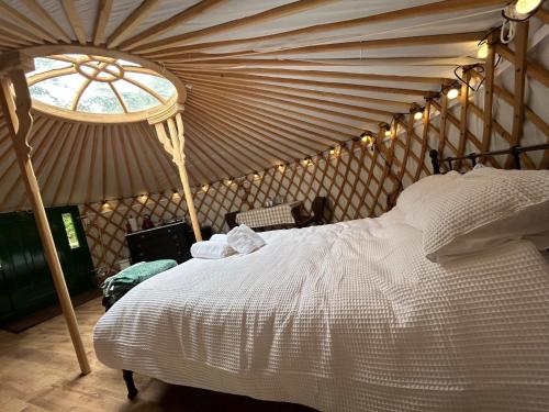 a bedroom with a large bed in a tent at Jimmy's Yurt in Shenley