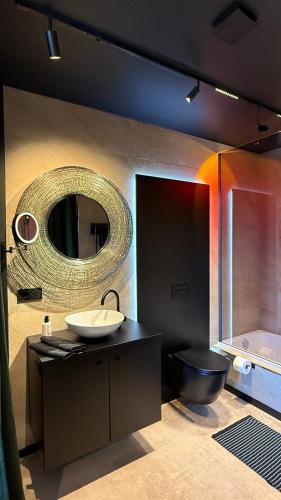 a bathroom with a sink and a mirror and a tub at Gleisbett 12-2 in Meiningen