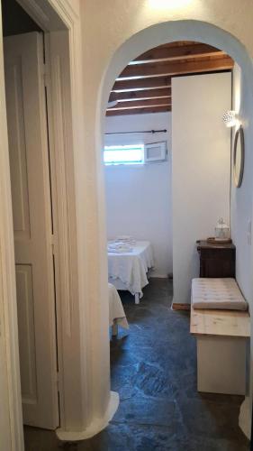 an archway in a room with a table in the background at Paraga Meltemi View in Platis Gialos