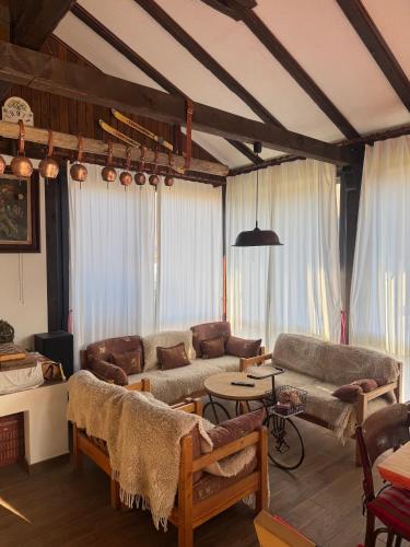 a living room with couches and a table at Villa Vera in Smilyan