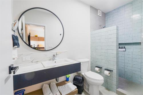 a bathroom with a sink and a mirror and a toilet at Casa Othir in Monterrey