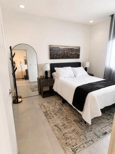 a bedroom with a large bed and a mirror at FIFA Monterrey Stay in Monterrey