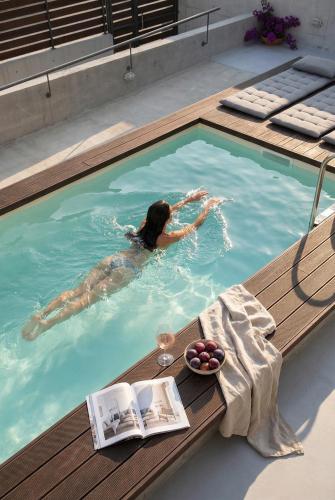 a woman is swimming in a swimming pool at Accessible Villa Katoi in Angón