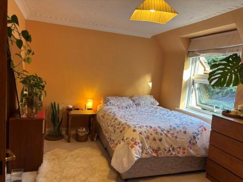 a bedroom with a bed and a window at The private Minton Mews No 3 in Bournemouth