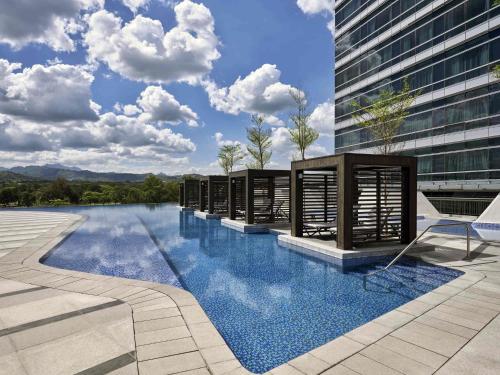 a swimming pool on the side of a building at Swissôtel Clark Philippines in Clark