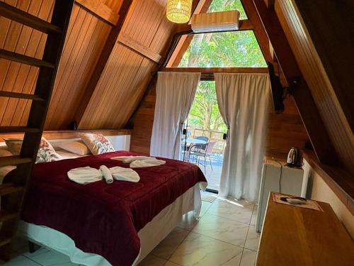 a bedroom with a bed with towels on it at Complexo Turístico Canaã in Nobres