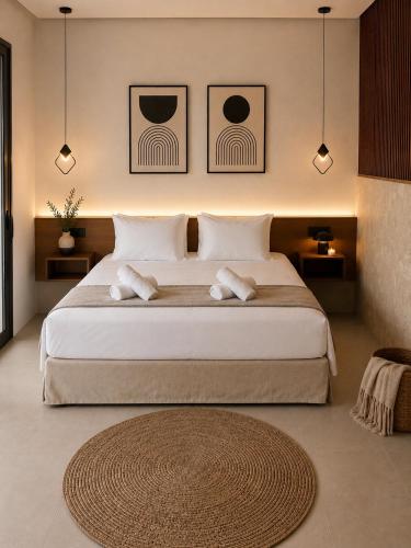 a bedroom with a large bed with two pillows at Kastri Beach Suites in Faliraki