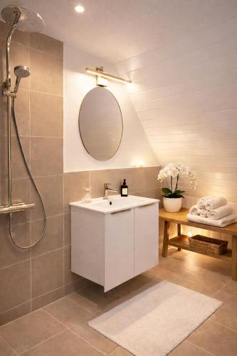 a bathroom with a white sink and a shower at Liseleje Badehotel in Liseleje