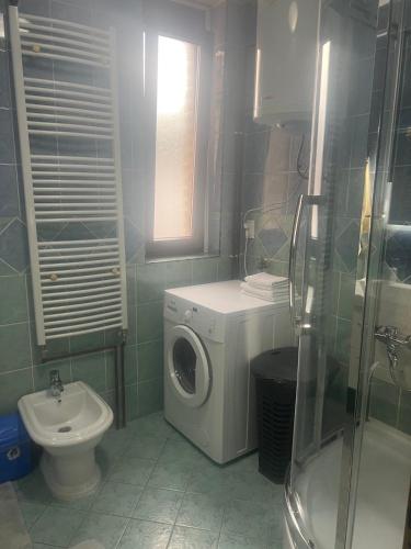a bathroom with a washing machine and a toilet at Hana in Konjic
