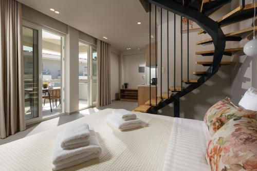 a bedroom with a bed with towels on it at Aeliana Thassos Studios & Lofts in Skala Rachoniou