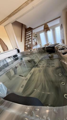a large pool of water in the middle of a room at Gîte le temps d'un instant in Samer