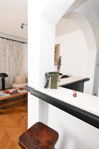 a living room with a table and a stool at Hostel Holiday Cetinje in Cetinje