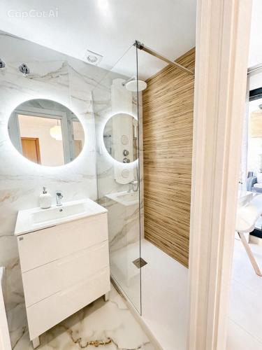 a bathroom with a sink and a shower at Marin Beach Apartments Patacona in Valencia